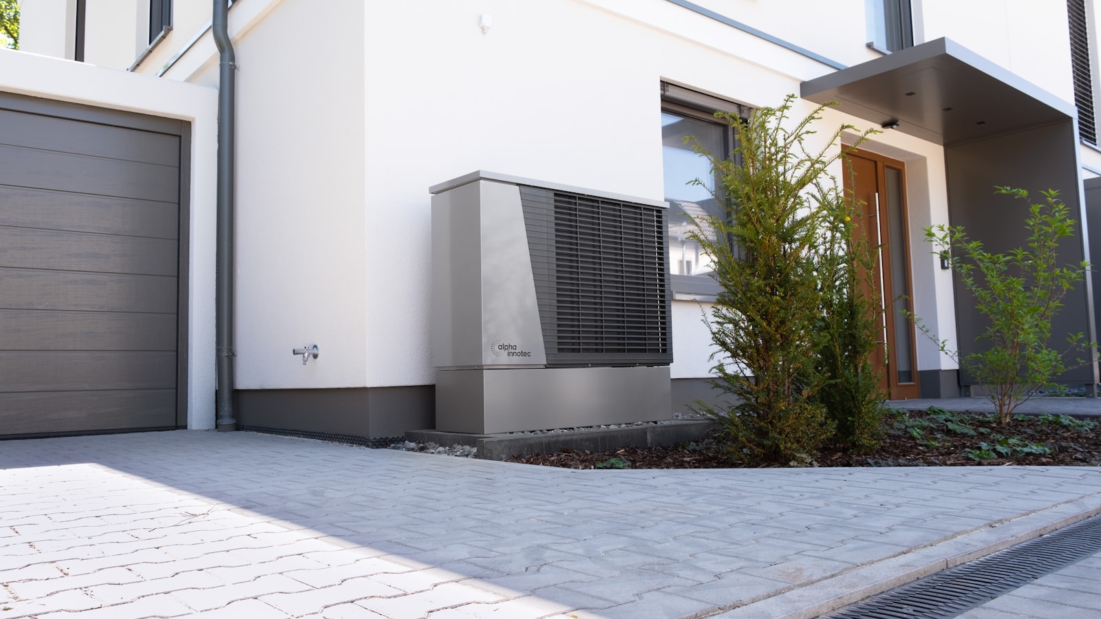 Modern house exterior with heat pump unit for off-grid cooling